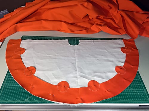 The orange and white tipi fabric laid on a table