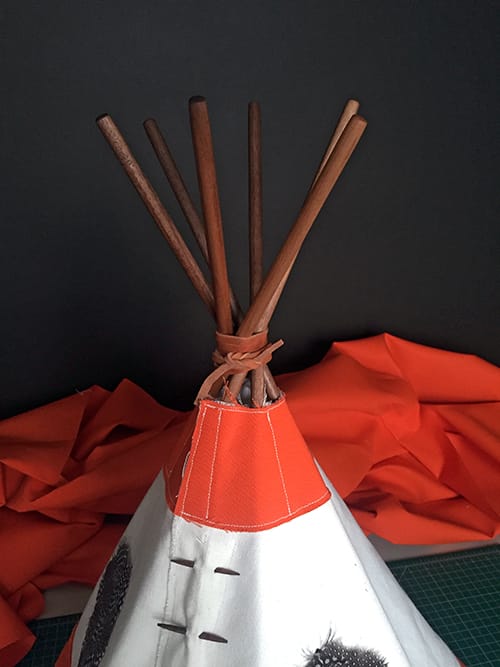 The top of the tipi with the waxed wooden poles in place