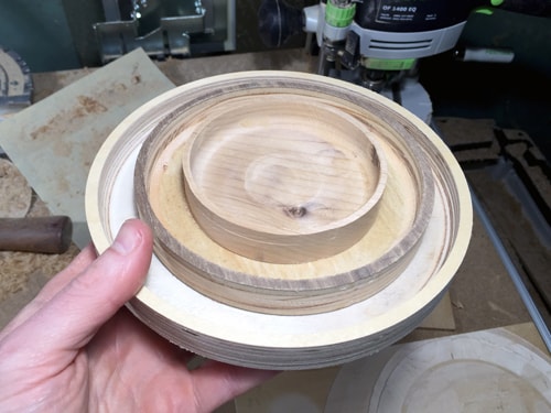 Three circular wooden dishes of different sizes